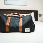 A packed travel bag sitting on a bed.